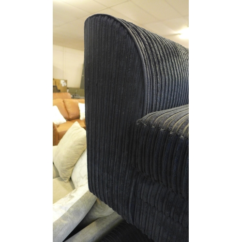 1486 - A black jumbo cord three seater sofa