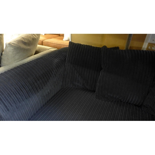 1487 - A black jumbo cord three seater sofa