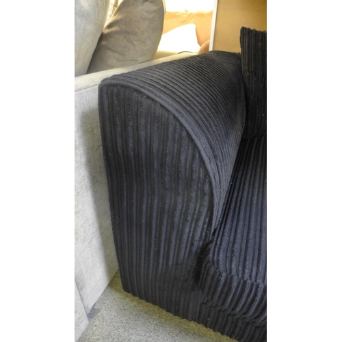 1487 - A black jumbo cord three seater sofa