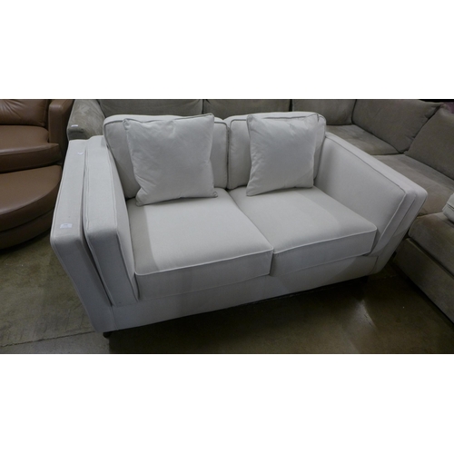 1354 - A light grey fabric upholstered two seater sofa