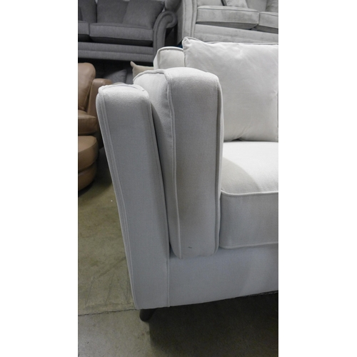 1354 - A light grey fabric upholstered two seater sofa