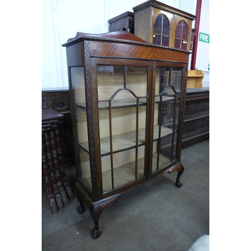 135 - A mahogany bow front two door display cabinet