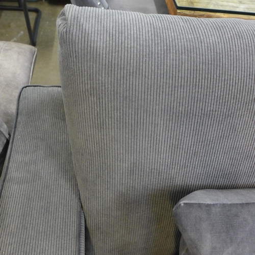 1427 - A charcoal corduroy three seater sofa