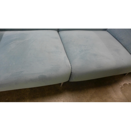 1431 - A sky blue velvet four seater sofa with chrome feet