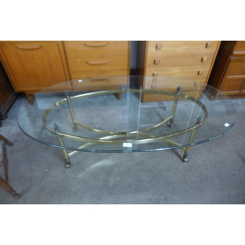 131 - An Italian style brass and oval glass topped coffee table