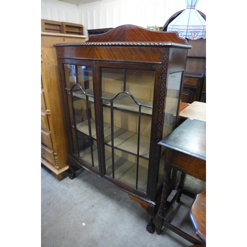 135 - A mahogany bow front two door display cabinet