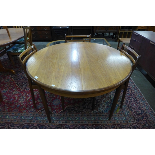 15 - A G-Plan Fresco teak extending dining table and four chairs