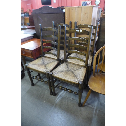 161 - A set of four elm and rush seated ladderback chairs