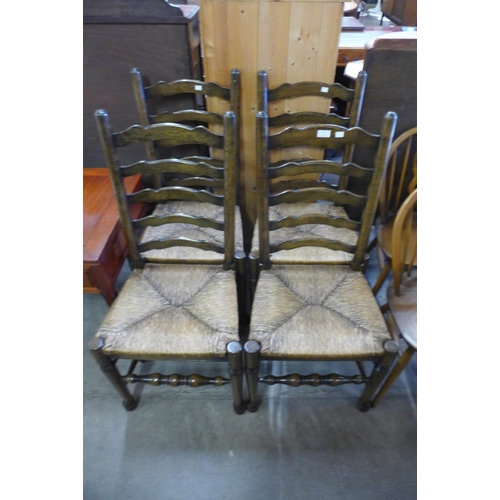 161 - A set of four elm and rush seated ladderback chairs