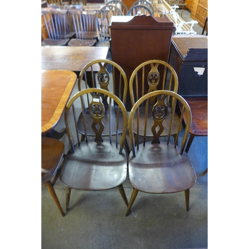 164 - A set of four Ercol Golden Dawn elm and beech fleur de lys chairs