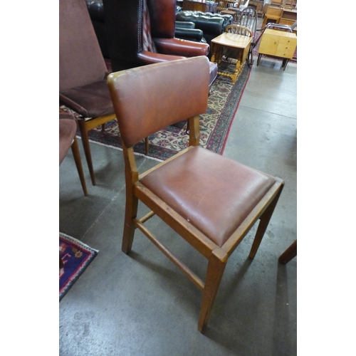 31 - A walnut draw-leaf table and four chairs