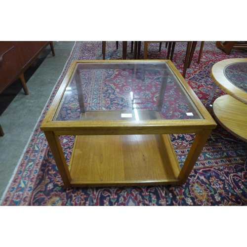 51 - A teak and glass topped square coffee table