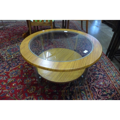 52 - A simulated teak, chrome and glass topped circular coffee table