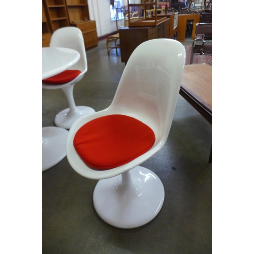 55 - An Arkana style white laminate tulip shaped table and four chairs