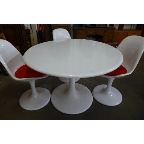 55 - An Arkana style white laminate tulip shaped table and four chairs