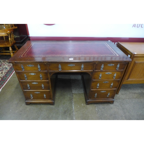 67 - A Victorian Gothic Revival oak and red leather topped desk, manner of A.W.N. Pugin