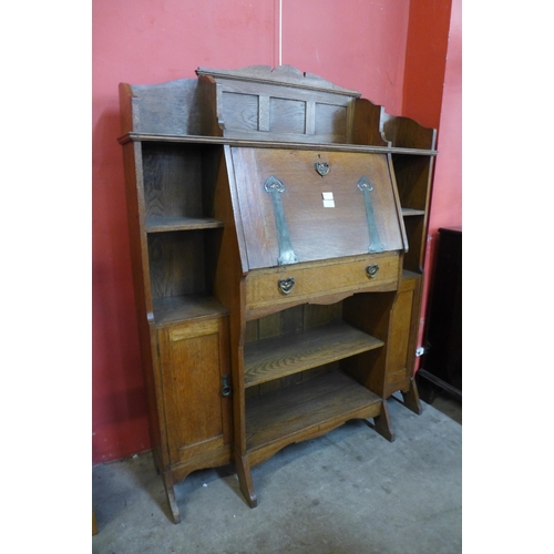 73 - A Liberty & Co. style Arts and Crafts oak bureau bookcase