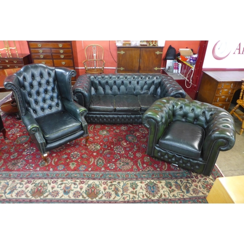 83 - A green leather Chesterfield three piece suite, comprising wingback armchair, club chair and a three... 