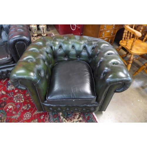 83 - A green leather Chesterfield three piece suite, comprising wingback armchair, club chair and a three... 