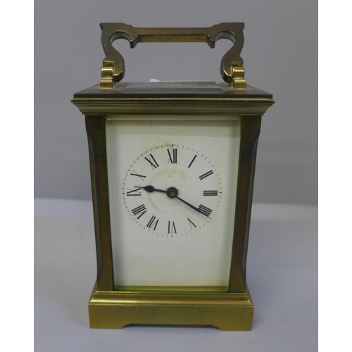 627 - A gilt brass carriage clock with key