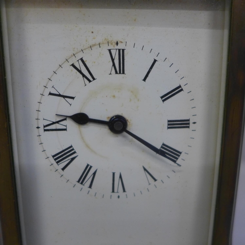 627 - A gilt brass carriage clock with key