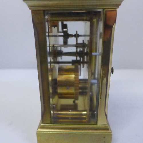 627 - A gilt brass carriage clock with key