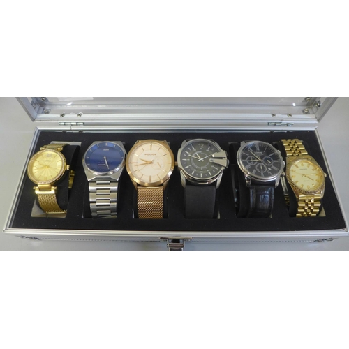 630 - An aluminium watch storage box with six wristwatches including Guess, Storm and Diesel