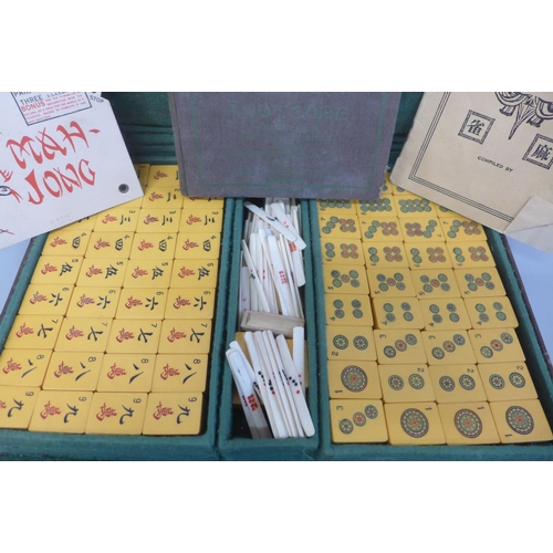 694 - A Mah-Jong game in a leather case with four wooden counters stands