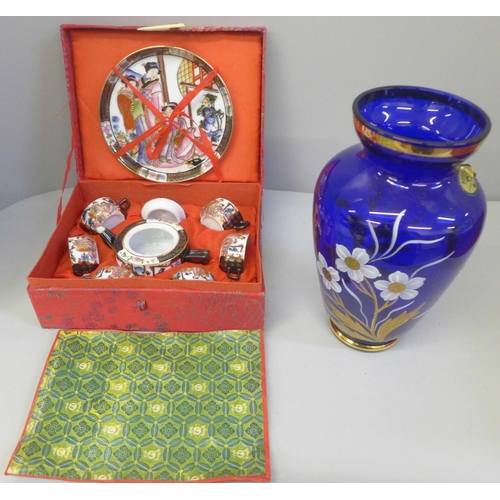 704 - A Japanese miniature tea set and a Bohemia blue glass vase, boxed