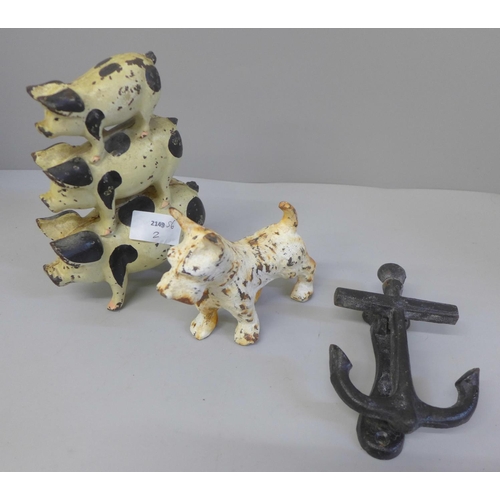 705 - A cast iron pig doorstop, a cast iron model of a terrier and a door knocker