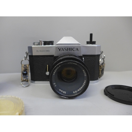 735 - A Yashica TL-Electro camera with 50mm lens and a spare 90-190mm lens