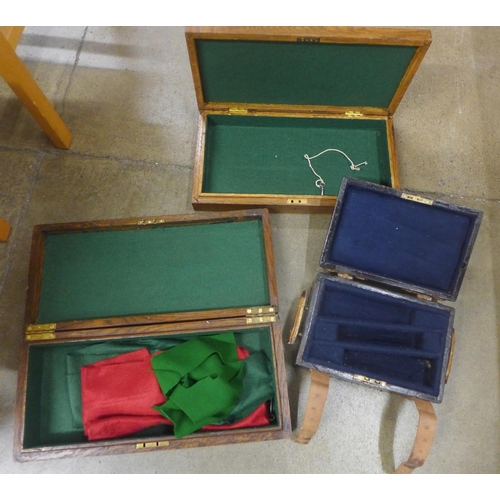 806 - Two wooden pistol cases and another wooden box with leather straps