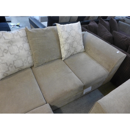 1594 - A sandstone upholstered corner sofa with patterned scatter back cushions