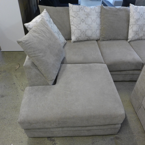 1594 - A sandstone upholstered corner sofa with patterned scatter back cushions