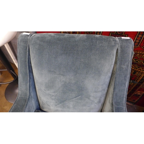 1394 - A petrol blue velvet swivel armchair