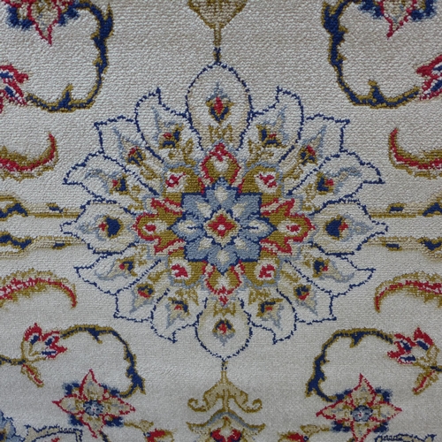 1521 - An ivory ground cashmere, full pile rug with a bespoke floral pattern 170cm x 120cm