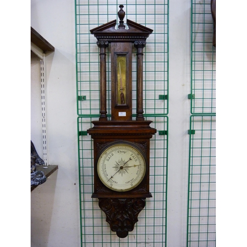 389 - A Victorian carved oak aneroid barometer