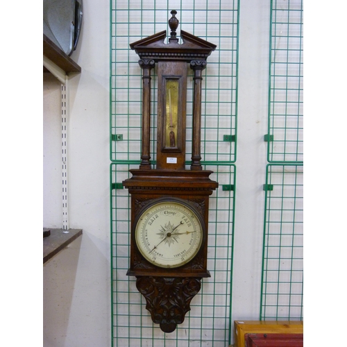 389 - A Victorian carved oak aneroid barometer