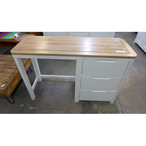 1329 - A Hove ivory painted and oak top three drawer desk/dressing table * this lot is subject to VAT