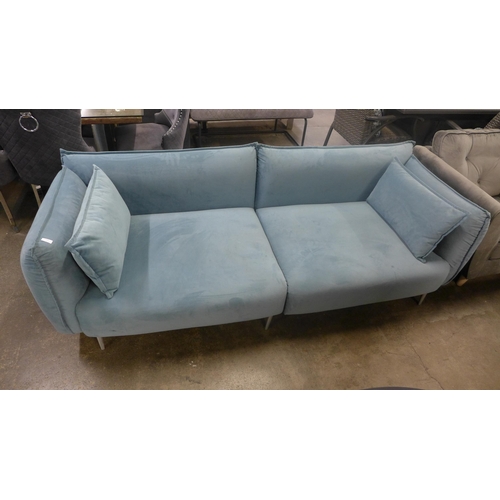 1361 - A sky blue velvet four seater sofa with chrome feet