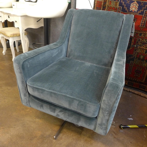 1376 - A petrol blue velvet swivel armchair