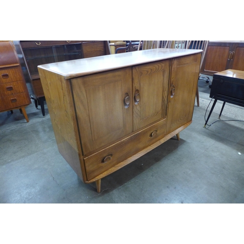 129 - An Ercol Blonde elm and beech Windsor sideboard