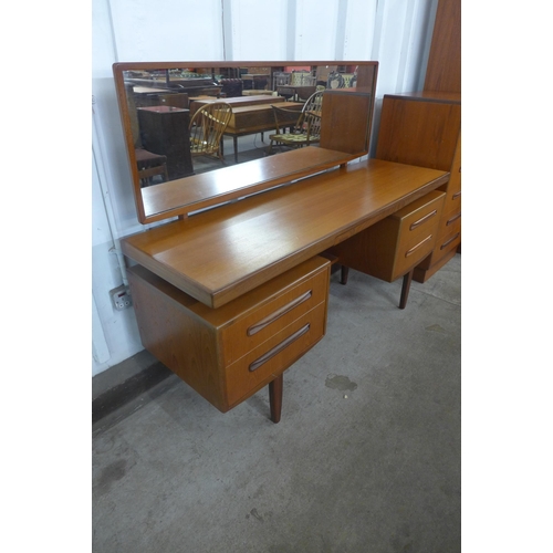 151 - A G-Plan Fresco teak four piece bedroom suite, comprising; dressing table, chest of drawers and two ... 