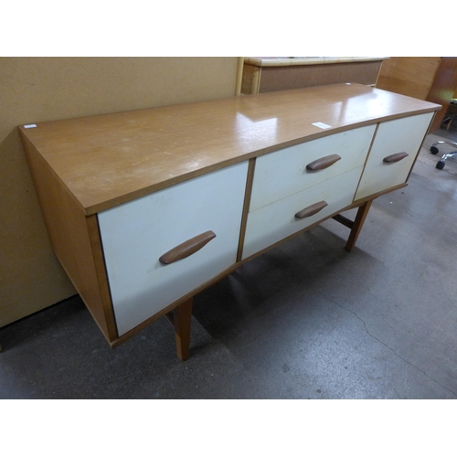 162 - A small painted teak concave sideboard