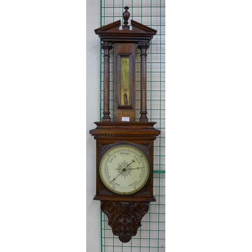 389 - A Victorian carved oak aneroid barometer