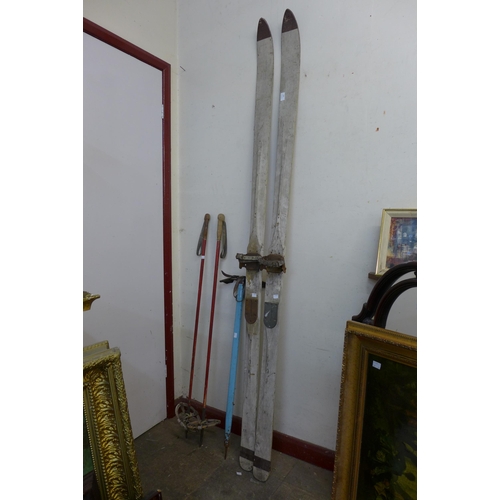 394 - A pair of vintage wooden skis, pair of sticks and a pick