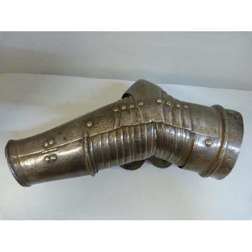 1007 - An articulated arm guard from a suit of armour, probably 16th or 17th century