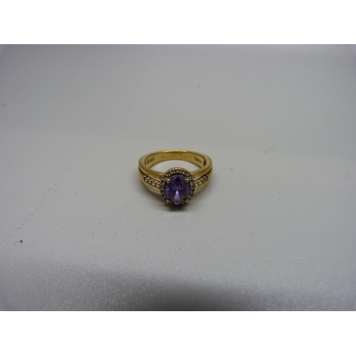 1063 - A silver gilt, amethyst and white stone ring, M