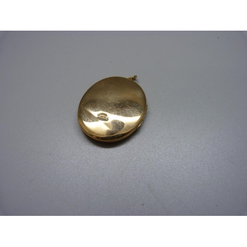 1080 - A 9ct gold locket, 13.8g, 33mm wide