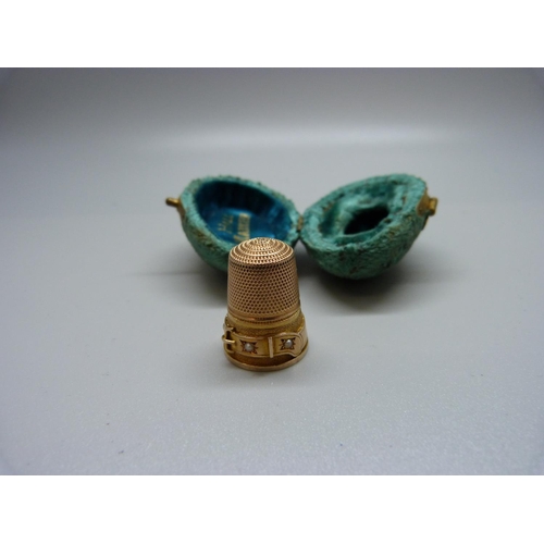 1084 - A yellow metal thimble with buckle detail and set with small pearls, with a case, 5.5g